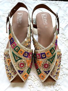 Hand crafted & hand embroidered leather Peshawari Chappal - in 100% leather embellished with Multicolored thread work & intricate sequence work  Available in UK Size 4,  Each item is individually crafted by a unique artisan and reflects his creativity and expression ! A Peshawari Chappal is a Traditional footwear design of Pakistan & takes its name from the city of Peshawar  It is a semi closed footwear consisting of two wide strips which cross over each other to join the sole of the sandal  The Peshawari Chappal has become increasingly popular in the fashion space of Pakistan . The urban youth wear this very often with jeans and Western clothes The Classic style of this shoe make it a perfect accessory for Weddings , Parties and Christmas events. Ideal for  casual and formal wear with bot Western Clothes, Footwear Design, Christmas Events, Embroidered Leather, Sequence Work, T Strap Sandals, Thread Work, Western Outfits, T Strap