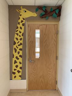 a giraffe painted on the side of a door in a hallway with wooden doors