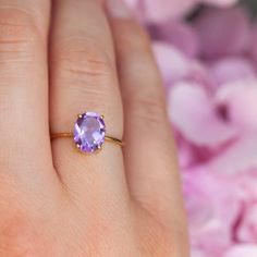 How can something so simple as an oval Amethyst solitaire ring, be so beautiful, you ask? The answer is in the gemstone itself. With a gorgeous vivid purple color, this ring just pops out on your finger and dazzles everyone. To turn it up a notch, add complimentary stacking rings, to create a one-of-a-kind ring set - s Elegant Purple Oval Birthstone Ring, Purple Oval Birthstone Ring, Purple Oval Ring With Prong Setting, Oval Solitaire Amethyst Ring For Anniversary, Dainty Oval Amethyst Promise Ring, Oval Amethyst Birthstone Ring Fine Jewelry, Oval Purple Solitaire Birthstone Ring, Oval Lavender Amethyst Ring For Gift, Oval Solitaire Amethyst Promise Ring