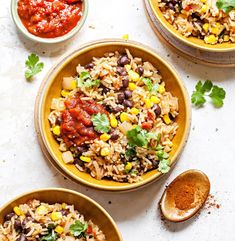 three bowls filled with mexican rice and beans