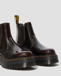 Step into the world of quirky fashion with the 2976 Quad Cherry Red Arcadia Chelsea Platform Boot! Originating from the Victorian era, this iconic style was first introduced by Dr. Martens in the 70s. Now, it's back and better than ever with a bold 1.5" platform sole. Not only does it make a statement, but it's also easy to slip on and off thanks to the elastic gusset. And with all the classic Docs DNA like grooved sides, heel-loop, and yellow stitching, you can't go wrong with this fashion-forw Chelsea Boots Dr Martens, Chelsea Platform Boots, Cherry Red Dr Martens, Doc Marten Chelsea, 2976 Chelsea Boots, Galaxy Converse, Galaxy Vans, Chelsea Boots Style, Platform Chelsea Boots