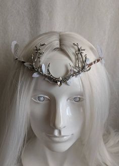 An ethereal woodland tiara featuring white leaves (including large white leaves) surrounding the piece and a moon charm with crystal in the center and two branches at its side. Perfect for weddings, cosplay, renaissance fairs, festivals, or any event of your choosing! White Crown Headpieces As Gift, Fantasy White Wedding Headpieces, White Fantasy Wedding Headpieces, Silver Fantasy Headpiece For Costume Party, Fantasy Wedding Headband Headpiece, Fantasy Wedding Headband, Fantasy Wedding Headpiece Adjustable, Fantasy Wedding Headpiece With Adjustable Fit, Adjustable Fantasy Wedding Headpiece