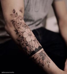 a person with a flower tattoo on their arm