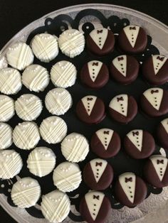 chocolates with white frosting are arranged in the shape of bow ties and tuxedos