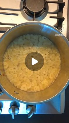 a pan filled with food sitting on top of a stove next to a burner