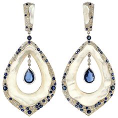 Cast from 18-karat gold, these stunning earrings are set with 4.0 carats of Kyanite, 23.92 carats mother of pearl and 2.61 carats of glimmering diamonds. FOLLOW MEGHNA JEWELS storefront to view the latest collection & exclusive pieces. Meghna Jewels is proudly rated as a Top Seller on 1stDibs with 5 star customer reviews. All items manufactured by us are handmade and can be customized or redesigned. Composition Size-75X34 Total Weight-24.82 Gold Weight(Gms)-18.092 Diamond Wt(Cts)-2.61 Kyanite Wt Diamond Dangle Earrings, Pearl Earrings Dangle, Stunning Earrings, Gold Earrings Dangle, Gold Drop Earrings, Fun Earrings, White Gold Diamonds, Mother Of Pearl, Beautiful Jewelry