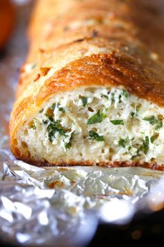 a close up of a piece of bread with cheese and spinach on it,