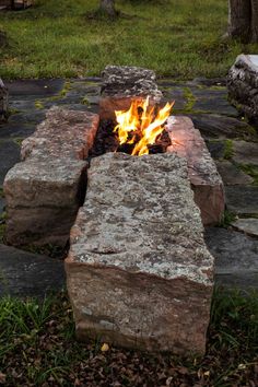 an outdoor fire pit made out of rocks