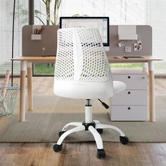 a white office chair sitting in front of a computer desk