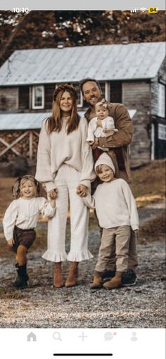 a family posing for a photo in front of a house