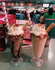 two ice cream sundaes with sprinkles and chocolate milkshakes