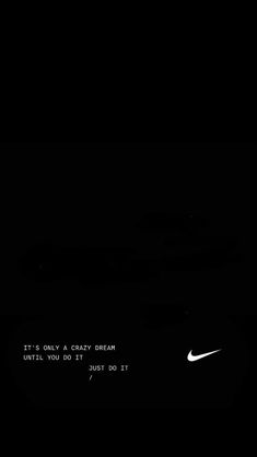 a black and white photo with the nike logo on it's left side in the dark