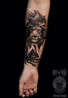 a tattoo on the arm of a person with a lion and triangle in his hand