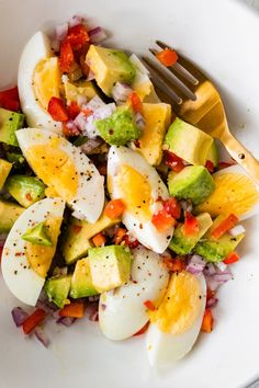 a salad with hard boiled eggs and vegetables