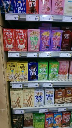 a shelf filled with lots of different flavored bars and packets on it's shelves