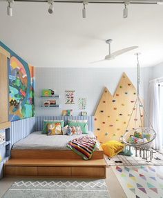 a child's bedroom with colorful wallpaper and artwork on the walls, including a swing bed