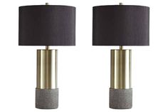 two grey and gold lamps with black shades