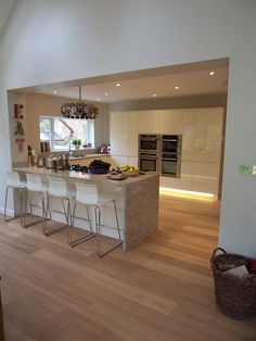 a kitchen with an island and several stools