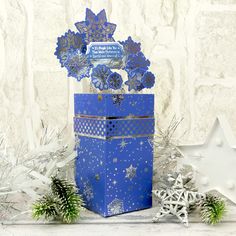 a blue gift box with snowflakes and decorations