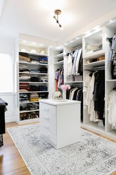 an organized walk in closet with drawers and clothes on hangers next to a piano