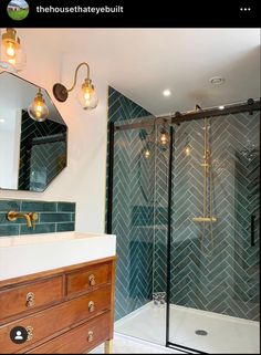 a bathroom with a walk in shower next to a white sink and wooden vanity top