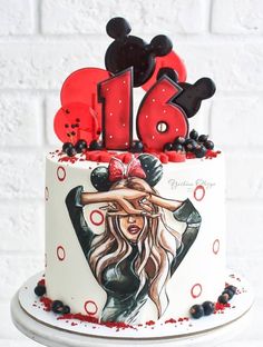 a birthday cake decorated with minnie mouse ears and an image of a woman's head