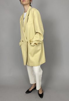 "Vintage Wool Blazer for Women Size L - XL | Pale Yellow Long Wool Blazer, fully lined, with big golden metallic buttons. Gorgeous blazer. Composition: 100% wool. Lining: 100% rayon. Measurements of the vintage wool blazer lying flat: Armpit to armpit: 58 cm | 22.8\" Length: 89 cm | 35\" Sleeves: 62 cm | 24.4\" Shoulder to shoulder: 47 cm | 18.5\" Waist: 53 cm | 20,9\" In beautiful vintage condition. This pale yellow wool blazer is photographed on a size S model (bust: 88 cm|35\", waist: 68|26\" Classic Spring Outerwear With Gold Buttons, Classic Blazer With Hidden Button Closure For Daywear, Classic Single Breasted Blazer For Daywear, Gold Blazer For Workwear In Spring, Classic Gold Outerwear For Spring, Gold Outerwear With Double Button Closure For Work, Gold Outerwear With Double Button Closure For Office, Gold Blazer With Gold Buttons For Spring, Gold Single Breasted Outerwear With Notch Lapel