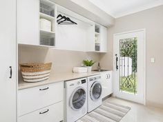 a washer and dryer in a white laundry room