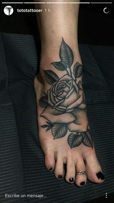 a woman's foot with a rose tattoo on the top and bottom of it