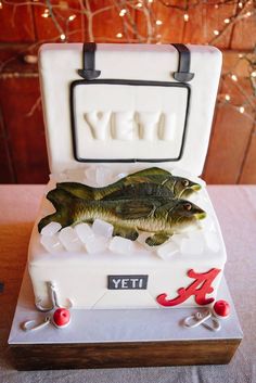 a cake shaped like a briefcase with a fish in it and letters on the inside