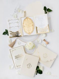 the wedding stationery is laid out on top of each other