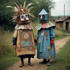 two people in costumes walking down a dirt road