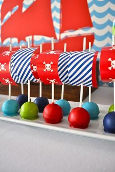 a row of red, white and blue cupcakes with pirate flags on them