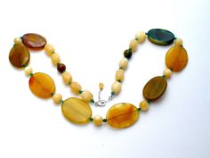 Statement Gemstone Jewelry - This is a substantial green & yellow agate and yellow quartz bead necklace. It is hallmarked 925, has sterling silver clasp and extension, chain, widest bead is 1.25" wide. It is 30" long, which includes the 2" extension, so it can be worn from 28" to 30" in length. Weight is 189 grams. Yellow Gemstone Beaded Necklaces With Round Beads, Yellow Agate Jewelry With Natural Stones, Yellow Gemstone Beaded Necklaces As Gift, Yellow Gemstone Round Beads Jewelry, Yellow Gemstone Beaded Necklaces For Gifts, Yellow Gemstone Beaded Necklace For Gifts, Yellow Gemstone Jewelry With Round Beads, Yellow Beaded Necklaces With Natural Stones As Gift, Yellow Beaded Necklaces With Natural Stones For Gifts