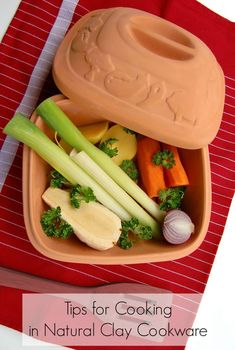 a bowl filled with vegetables sitting on top of a table