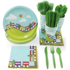 children's party supplies including plates, forks and napkins with train design on them