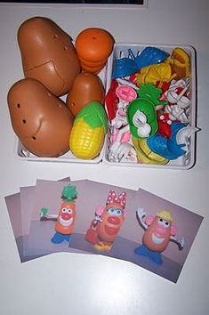 an assortment of toys in plastic containers on a table