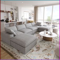 a living room filled with furniture next to a large open floor plan and lots of windows