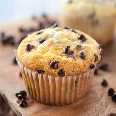 a muffin with chocolate chips on a cutting board