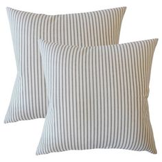 two striped pillows sitting next to each other