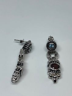 Vintage Bohemian Garnet Earring 925 Sterling Silver Dangle Main stone Bohemian Garnet and blue topaz Lovely handmade silver work Over an inch 92.5% Sterling Silver All jewelry is shipped free in the US in a nice gift box. Check out our over a THOUSAND great reviews Luxury Silver Earrings With Gemstone Accents, Silver Topaz Dangle Earrings, Silver Blue Topaz Drop Earrings, Silver Topaz Earrings With Gemstone Accents, Silver Jewelry With Blue Topaz, Luxury Silver Topaz Earrings, Silver Topaz Gemstone Earrings, Silver Topaz Earrings With Gemstone, Silver Dangle Earrings With Gemstone Accents