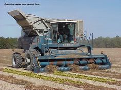 a large blue truck driving through a field