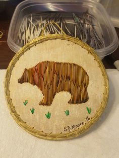 there is a bear made out of bamboo in the shape of a pincuss