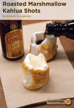 a bottle of beer is being poured into some kind of pastry that's sitting on a table