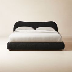 With its shapely curves and cloud-like presence, soft black boucle bed designed by  Ross Cassidy  is reminiscent of 1930s Italian design. The softest boucle wraps a frame supported by black walnut legs with a mid-tone stain, certified sustainable by the Forest Stewardship Council ®. It's a subtle nod to traditional camel-back silhouettes, updated by a dose of Ross' signature flair. CB2 exclusive.     Cotton-poly blend velvet  Solid black walnut legs, certified sustainable by the Forest Stewardsh Black Upholstered Bed, Black Leather Bed, White Queen Bed, King Upholstered Bed, Queen Upholstered Bed, American Black Walnut, Velvet Bed, Leather Bed, Home Modern