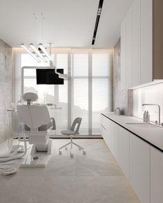 a modern dentist's office with all white furniture and minimalist lighting, along with large windows