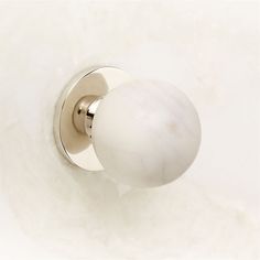 a white door knob with a marbled ball on it's side and a metal handle