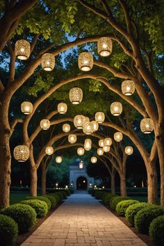 an archway with lanterns hanging from it's sides and trees lining the walkway between them