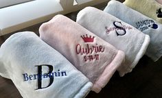 three personal towels with the names of different countries on them are lined up in front of a window