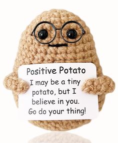 a crocheted potato holding a sign that says positive potato i may be a tiny potato, but i believe in you go do your thing